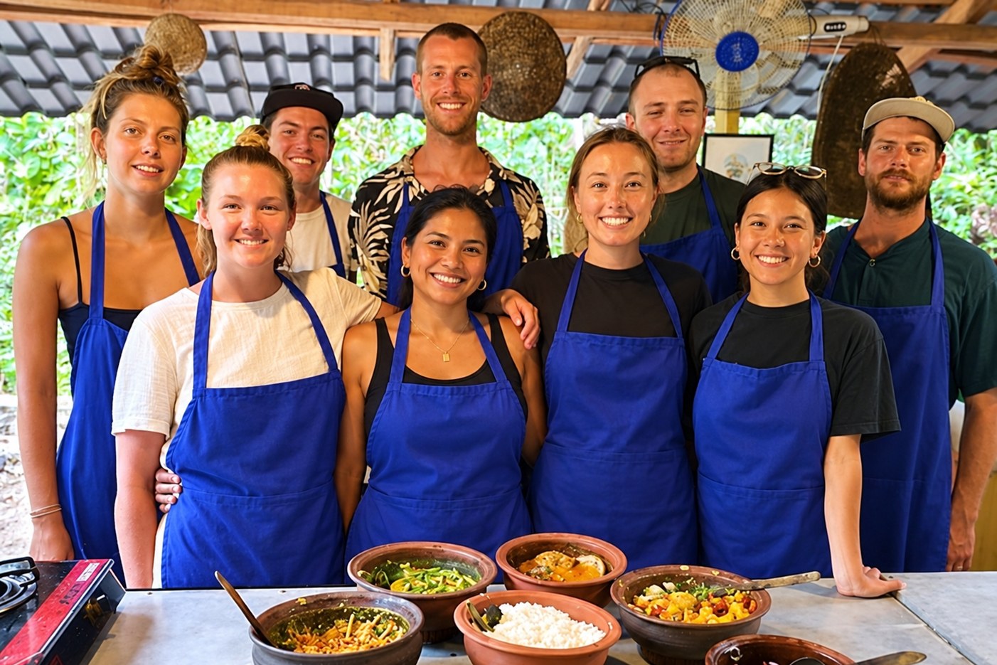 Guest in a blue blouse preparing Sri Lankan food at a cookery class table in Ella